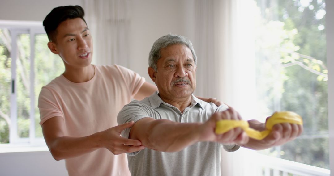 Senior Man Stretching with Physio Support Using Band