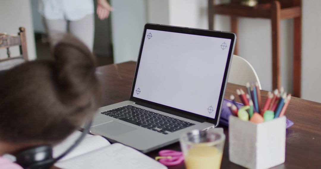 Young Girl Engaged in Online Learning with Laptop at Home