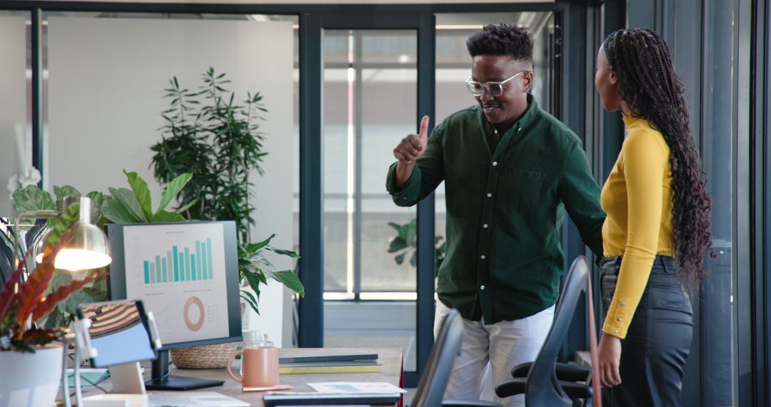 Colleagues Discussing Project Strategies in Modern Office Environment