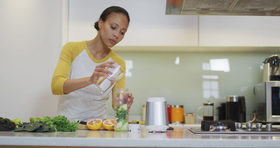 Woman Preparing Healthy Smoothie in Modern Kitchen - Free Images, Stock Photos and Pictures on Pikwizard.com