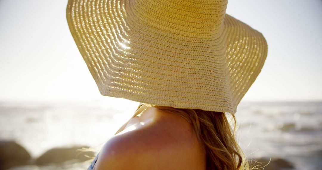 Woman Enjoying Beach Sunset with Wide-Brimmed Hat - Free Images, Stock Photos and Pictures on Pikwizard.com