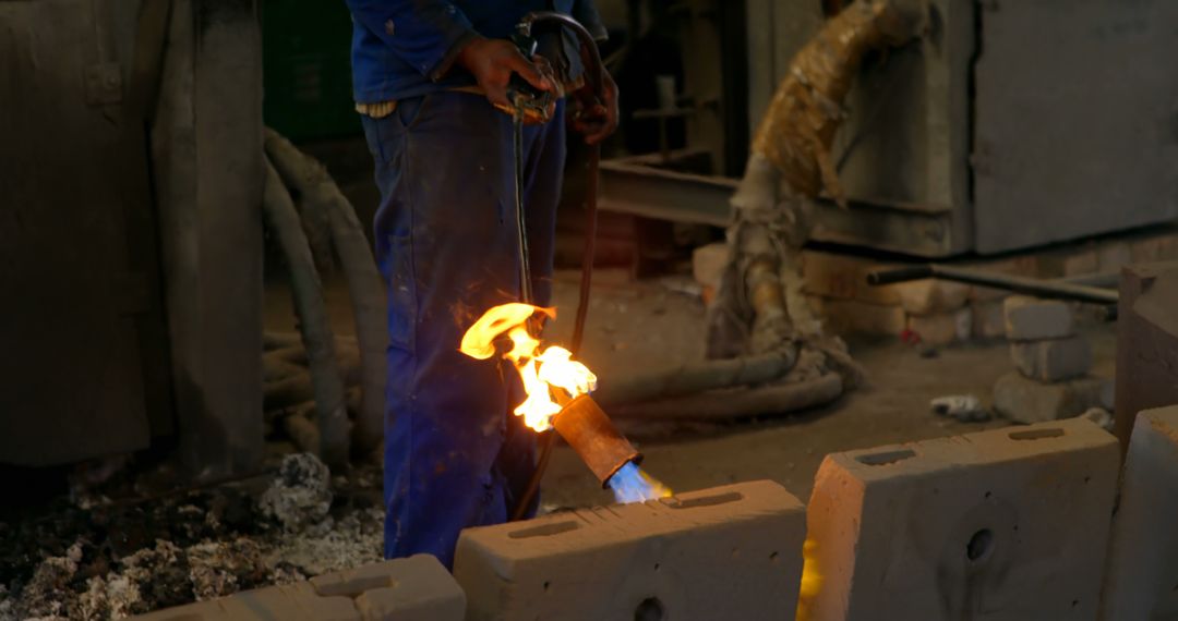 Industrial Worker Using Blowtorch on Brick in Factory - Free Images, Stock Photos and Pictures on Pikwizard.com