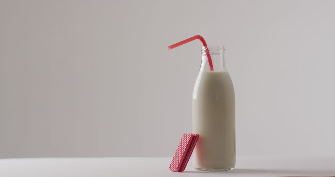 Milk Bottle with Pink Straw and Waffle Cookie in Minimalist Style - Free Images, Stock Photos and Pictures on Pikwizard.com