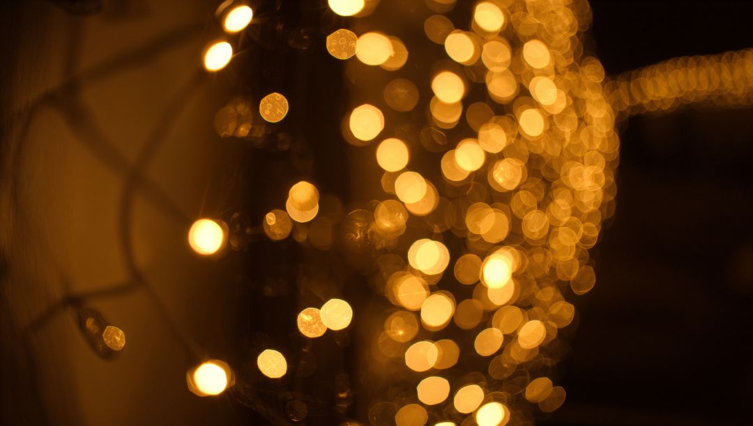 Golden bokeh string lights creating warm ambient glow for holiday and event decor backdrops