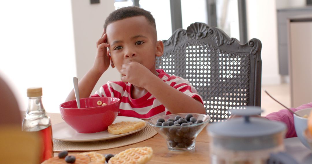 Young Boy Enjoying Breakfast with Waffles and Blueberries at Home - Free Images, Stock Photos and Pictures on Pikwizard.com