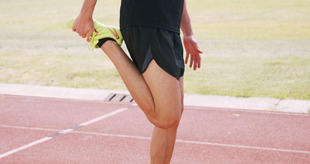 Athlete Stretching Hamstring Muscle on Running Track - Free Images, Stock Photos and Pictures on Pikwizard.com