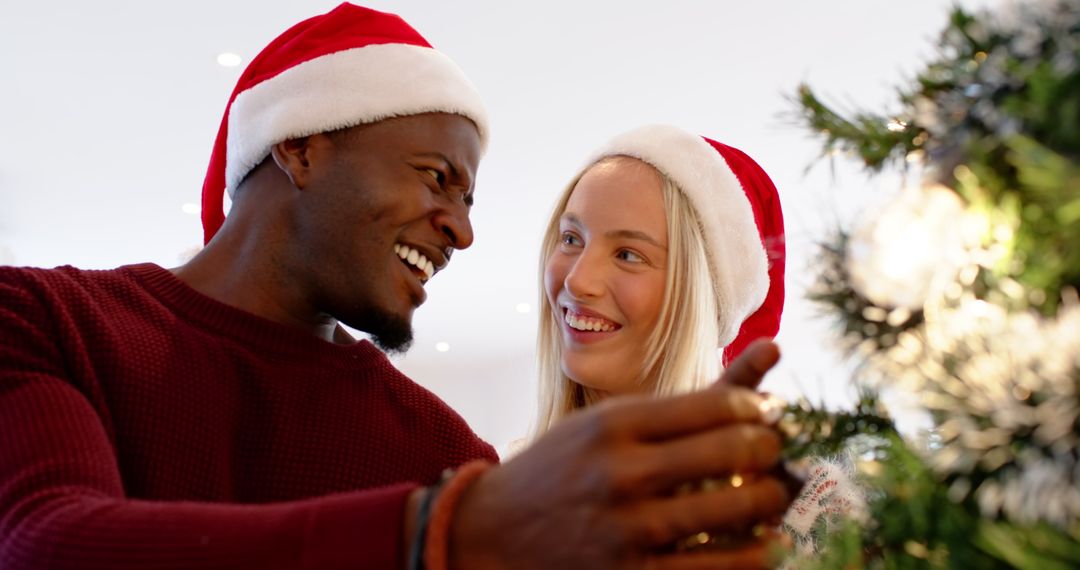 Diverse Couple Decorating Christmas Tree with Joy