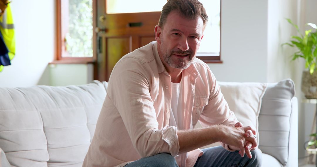 Senior Man Relaxing on Couch in Modern Entryway
