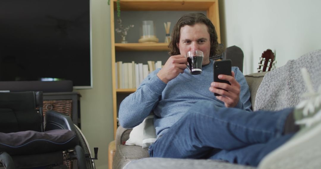 Man Relaxing at Home with Coffee and Smartphone - Free Images, Stock Photos and Pictures on Pikwizard.com