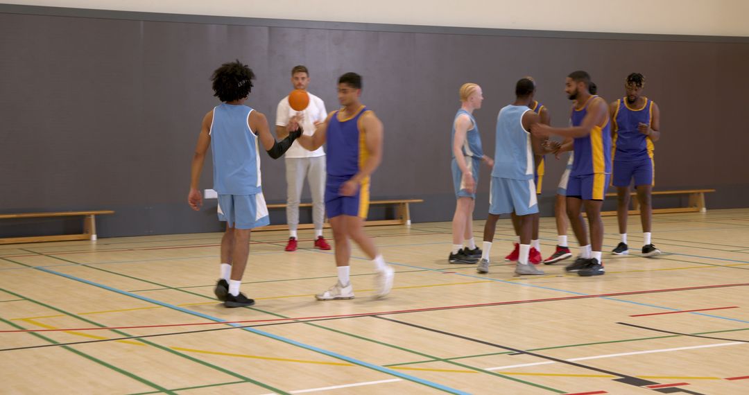 Diverse Basketball Team Practicing Indoors with Coach