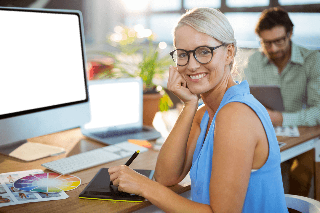 Smiling Graphic Designer Using Tablet in Modern Office with Transparent Screen