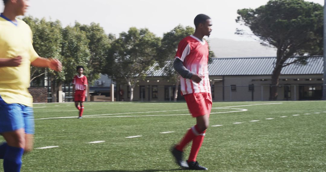 Young Soccer Players Practicing on Sunny Field