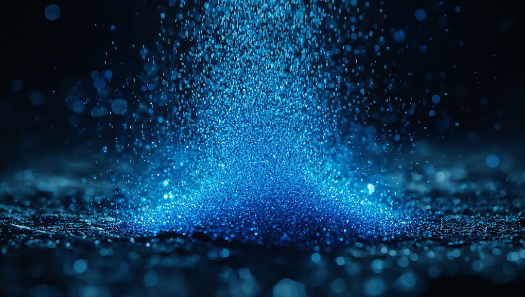 Luminous Blue Particles Cascading onto Reflective Surface