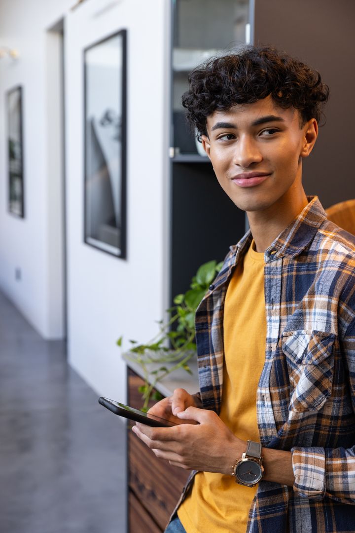 Modern Office Worker Using Smartphone in Stylish Corridor