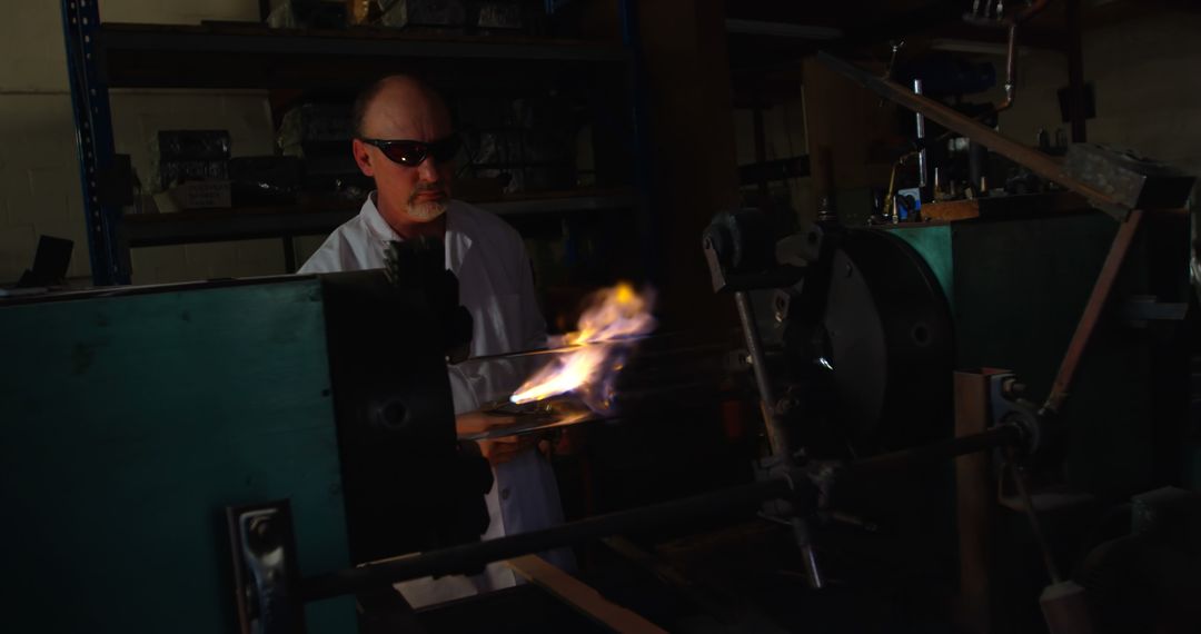 Engineer Working with Flamethrower in Industrial Laboratory - Free Images, Stock Photos and Pictures on Pikwizard.com