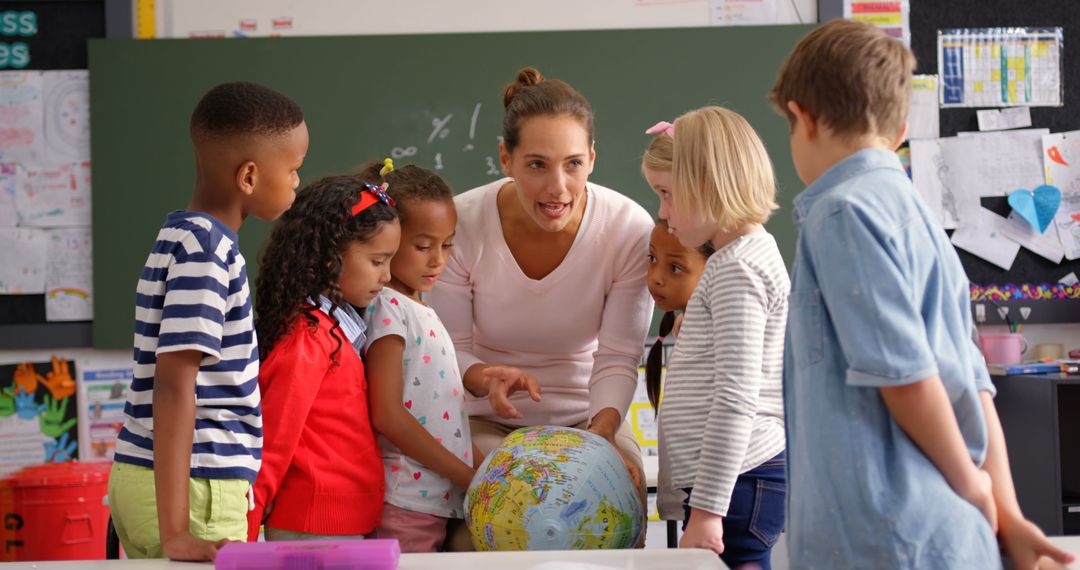 Teacher Engaging Schoolchildren with Globe in Interactive Classroom