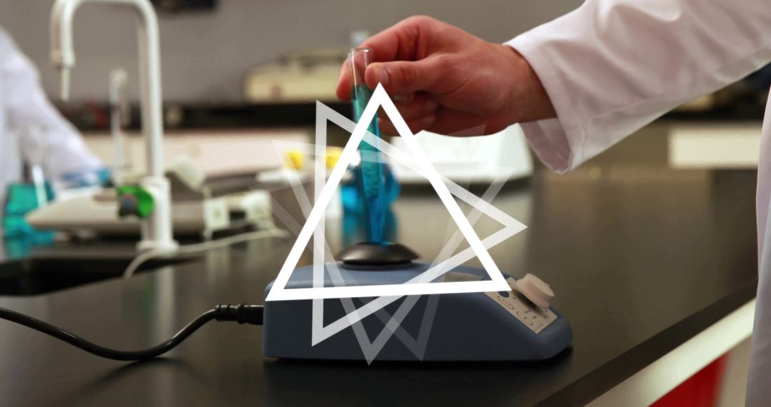 Hand Holding Test Tube in Research Laboratory Setting