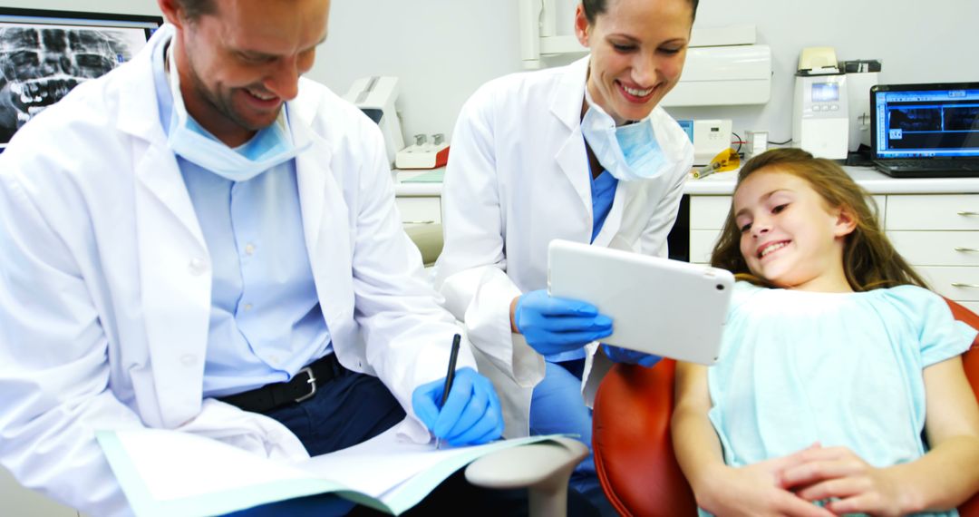 Dentists consulting with young patient in dental clinic - Free Images, Stock Photos and Pictures on Pikwizard.com