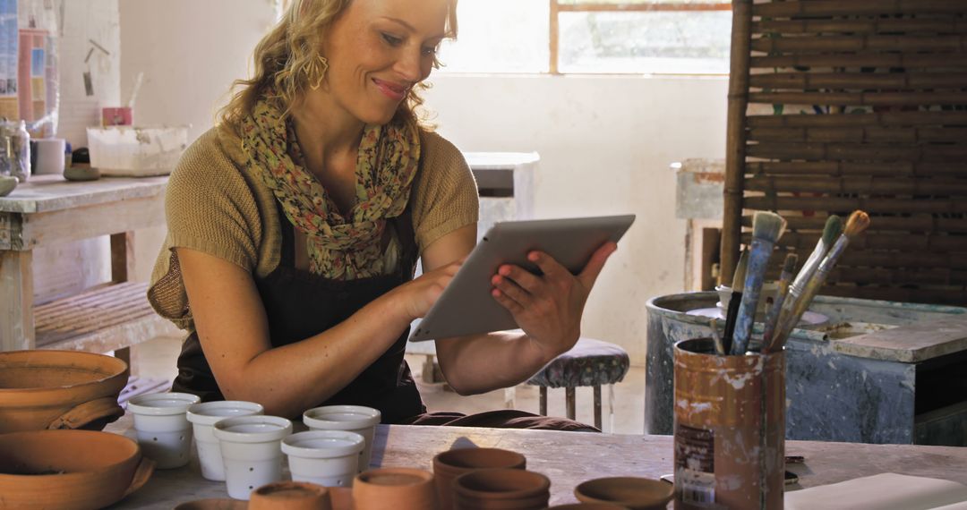 Female Artist Using Digital Tablet in Pottery Studio - Free Images, Stock Photos and Pictures on Pikwizard.com