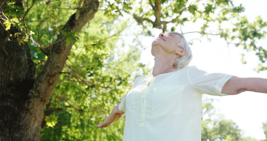 Senior Woman Enjoying Freedom and Fresh Air in Nature Park - Free Images, Stock Photos and Pictures on Pikwizard.com