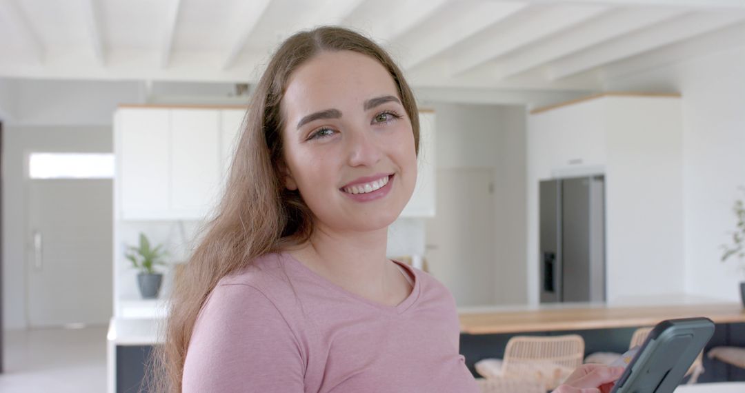 Smiling Woman Holding Smartphone in Modern Home Interior - Free Images, Stock Photos and Pictures on Pikwizard.com