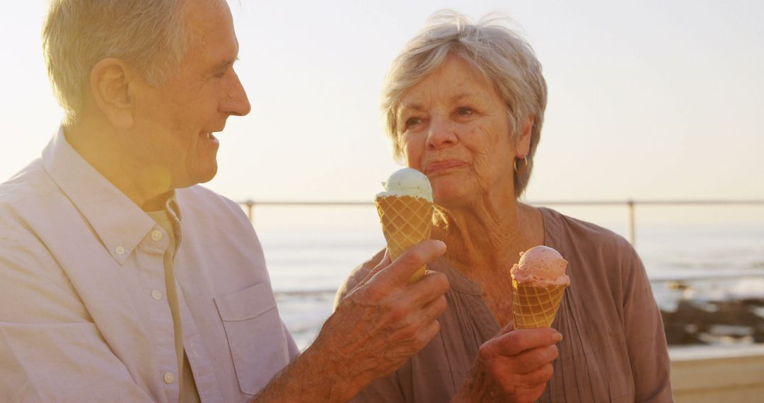 Senior Couple Enjoying Ice Cream Together at the Beach - Free Images, Stock Photos and Pictures on Pikwizard.com