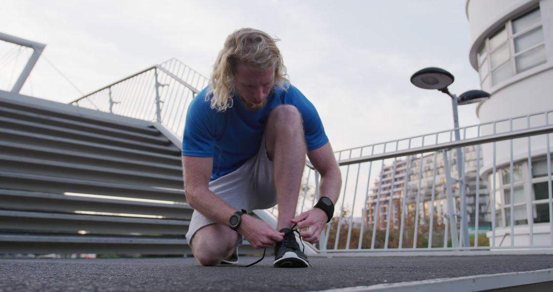 Male Runner Tying Shoes Before Outdoor Workout - Free Images, Stock Photos and Pictures on Pikwizard.com