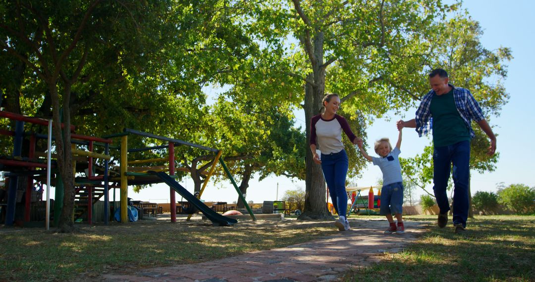 Family Strolling Through Lush Park on Sunny Day - Free Images, Stock Photos and Pictures on Pikwizard.com