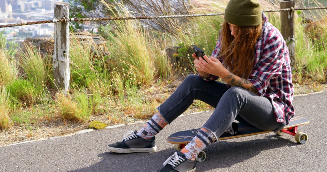 Young Woman on Skateboard Using Smartphone - Free Images, Stock Photos and Pictures on Pikwizard.com