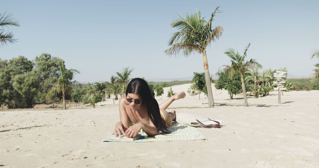 Woman Reading Book on Sandy Beach on a Sunny Day - Free Images, Stock Photos and Pictures on Pikwizard.com