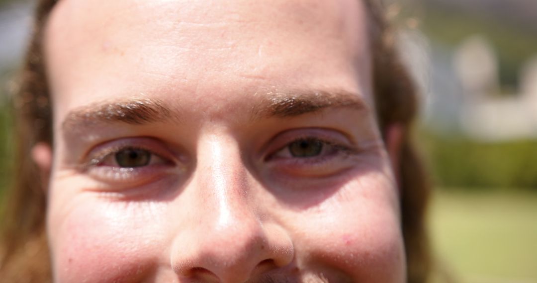 Close-up of Young Man's Eyes Smiling in Bright Sunlight
