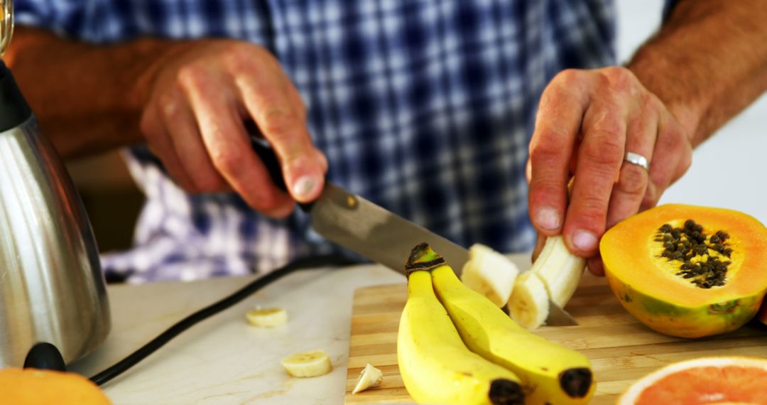 Man prepping fruit in kitchen for healthy breakfast - Free Images, Stock Photos and Pictures on Pikwizard.com