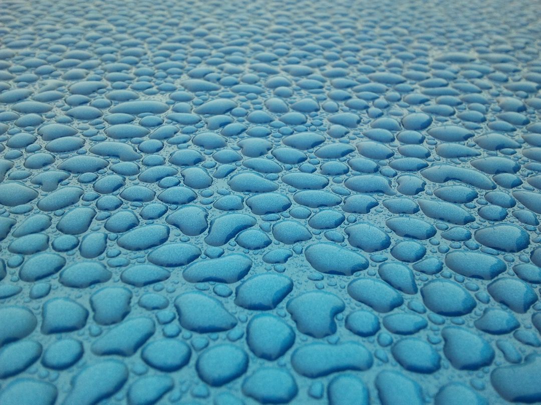 Close-up of Water Droplets on Blue Surface with Textured Pattern - Free Images, Stock Photos and Pictures on Pikwizard.com