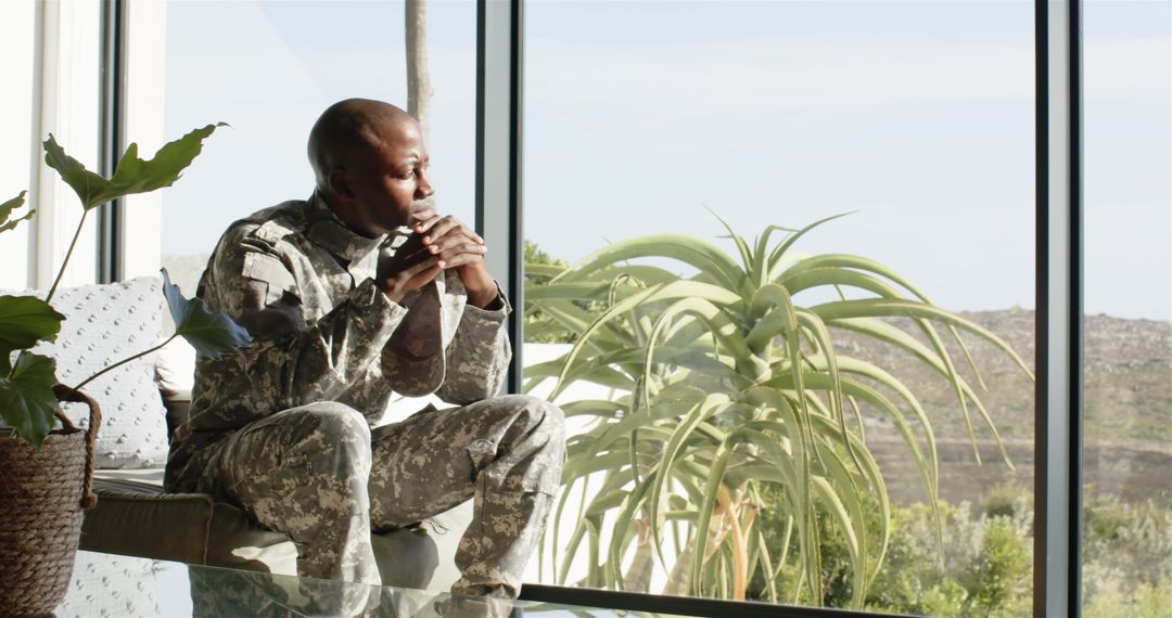 Contemplative Soldier in Military Uniform by Window