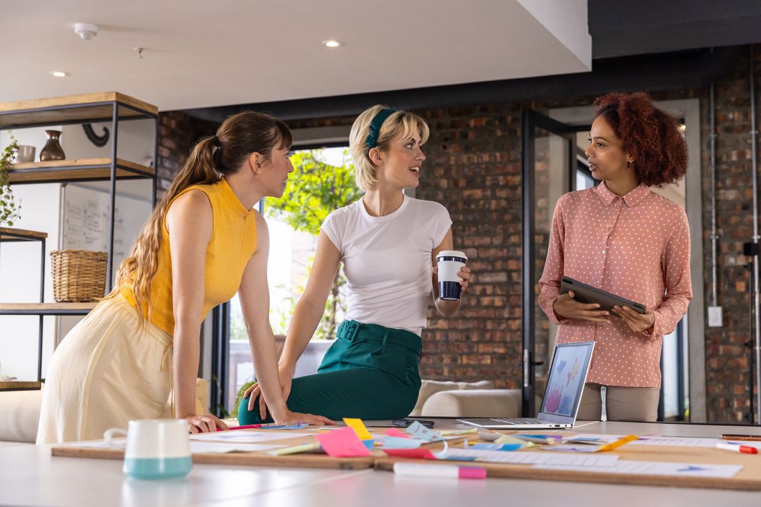 Diverse Team Collaborates Over Charts in Modern Loft Office