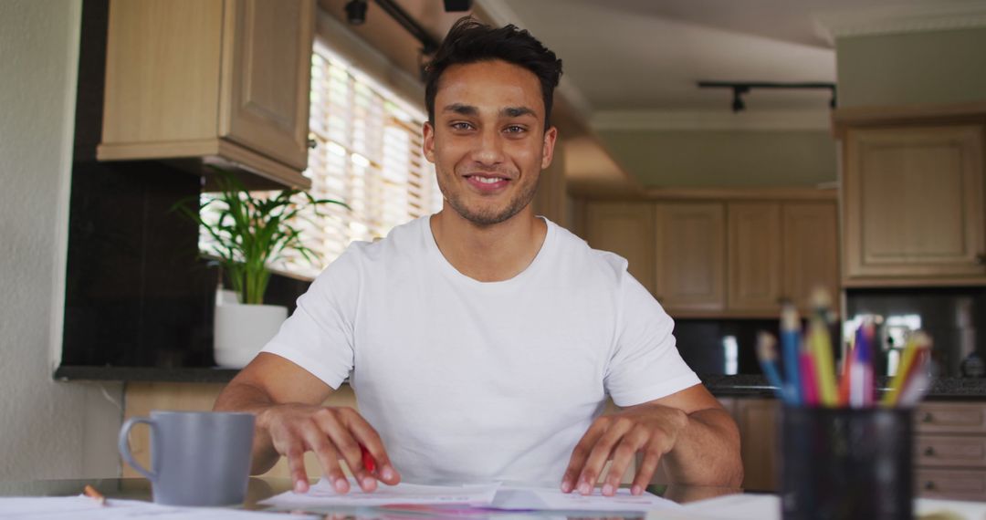 Smiling Latin Man Video Calling from Home Kitchen