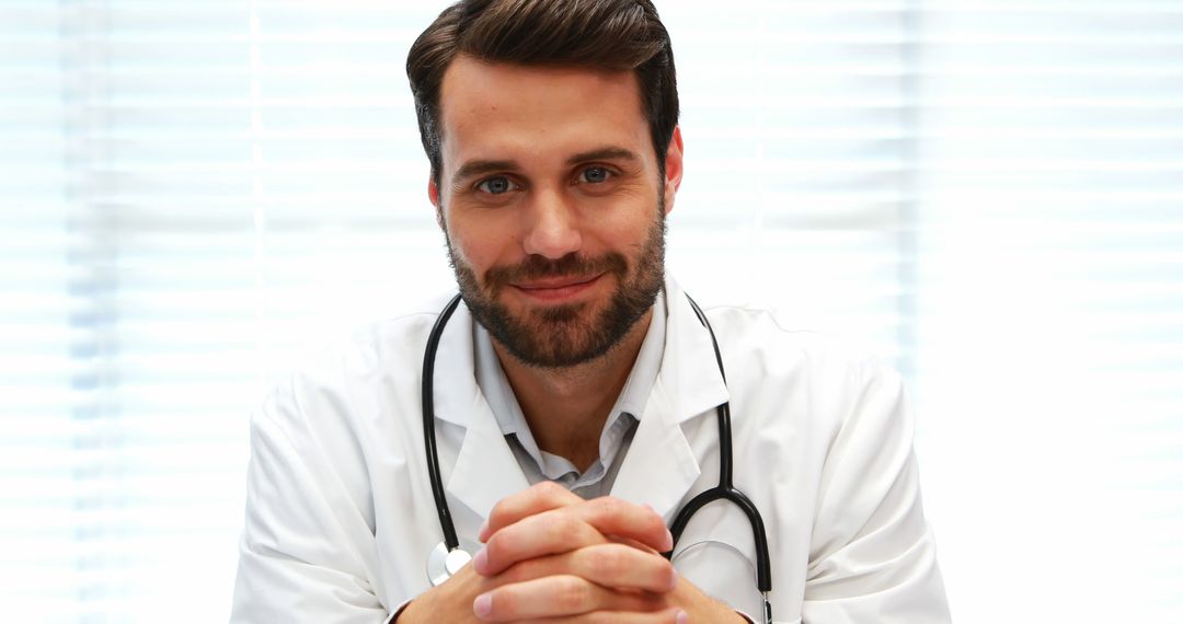 Confident Male Doctor Wearing Lab Coat and Stethoscope Smiling - Free Images, Stock Photos and Pictures on Pikwizard.com