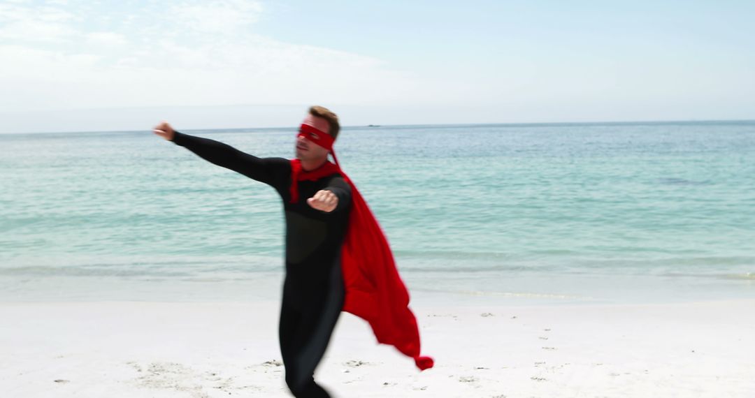 Man Dressed as Superhero Enjoying Playout Session on Beach - Free Images, Stock Photos and Pictures on Pikwizard.com