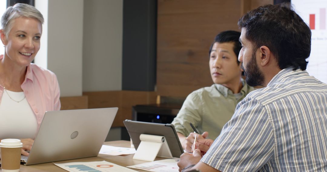 Diverse Team Collaborates on Data Strategy in Modern Office