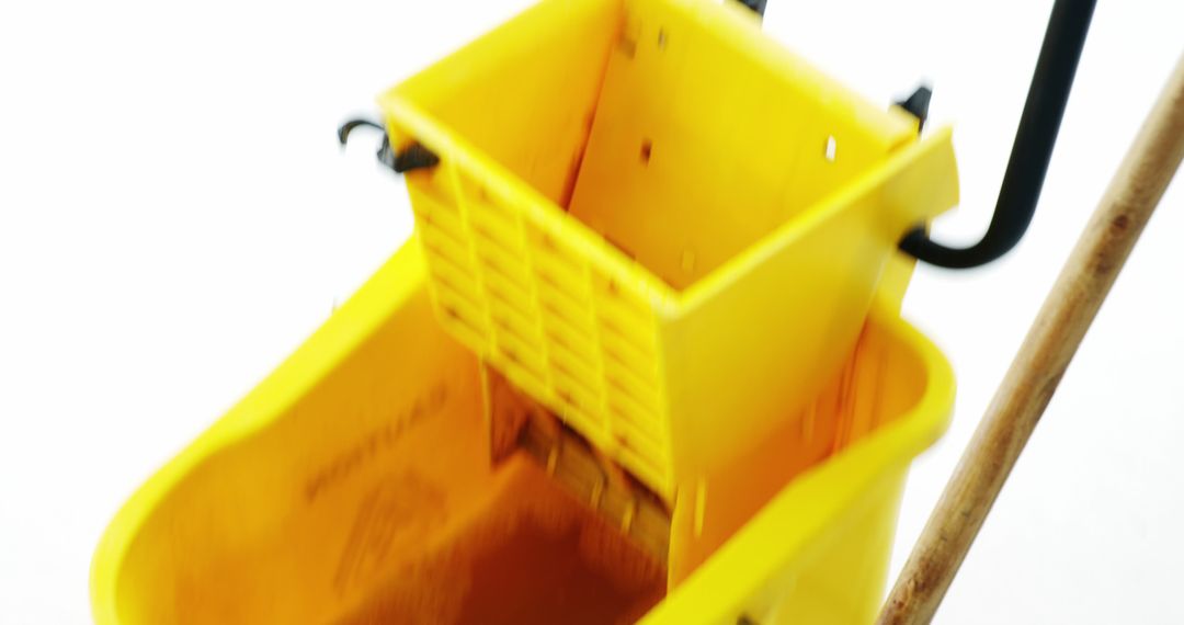 Close-Up of Yellow Mop Bucket with Wringer - Free Images, Stock Photos and Pictures on Pikwizard.com