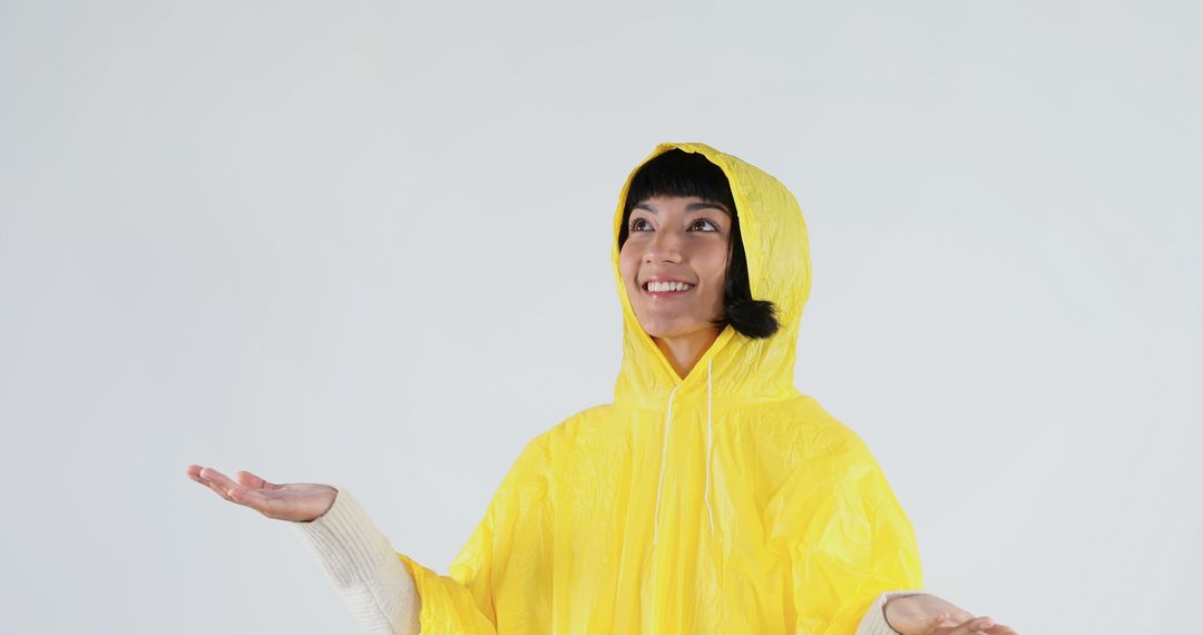 Woman Smiling in Yellow Raincoat Looking at Sky - Free Images, Stock Photos and Pictures on Pikwizard.com