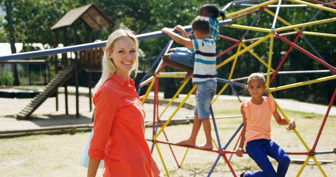 Female Teacher Supervising Children Playing on Playground Climbing Frame - Free Images, Stock Photos and Pictures on Pikwizard.com