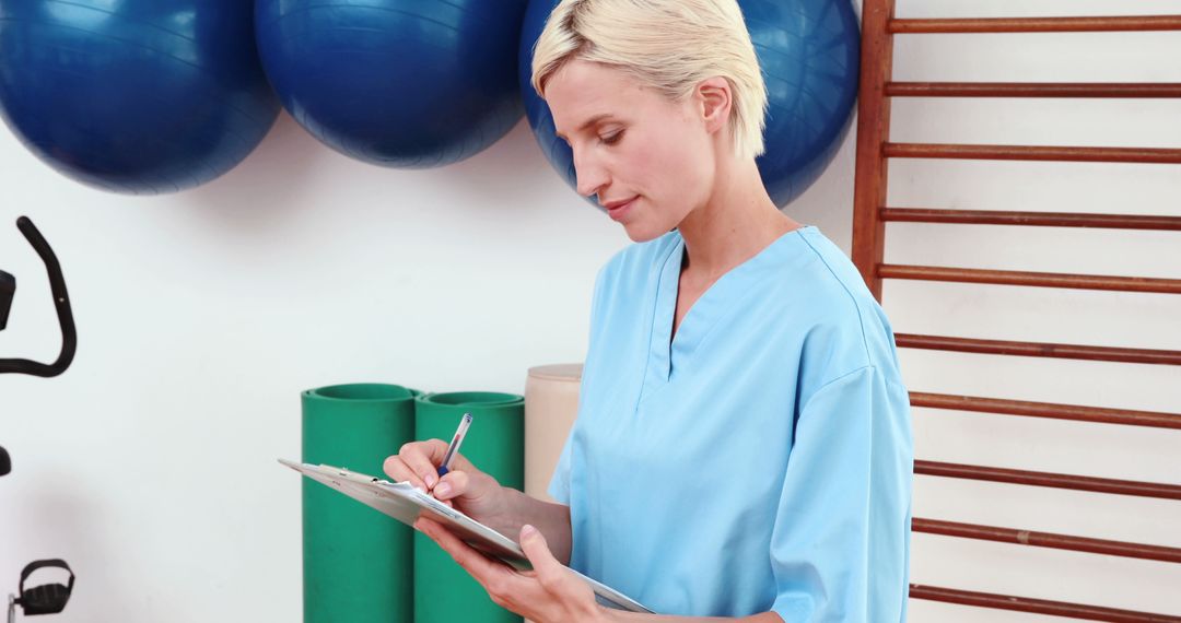 Female Physiotherapist Writing on Clipboard in Gym - Free Images, Stock Photos and Pictures on Pikwizard.com