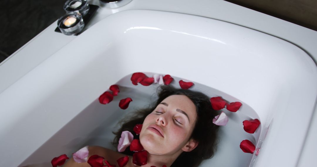 Woman Relaxing in Bathtub with Rose Petals and Candles - Free Images, Stock Photos and Pictures on Pikwizard.com