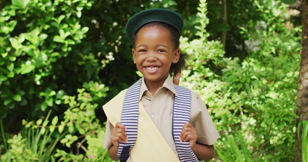 Smiling African American Girl in Scouting Costume in Lush Garden - Free Images, Stock Photos and Pictures on Pikwizard.com