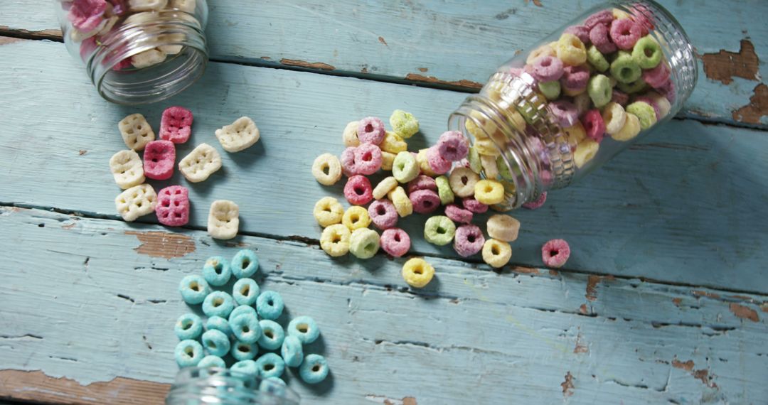 Colorful Cereal Spilled from Jars on Rustic Wooden Table - Free Images, Stock Photos and Pictures on Pikwizard.com