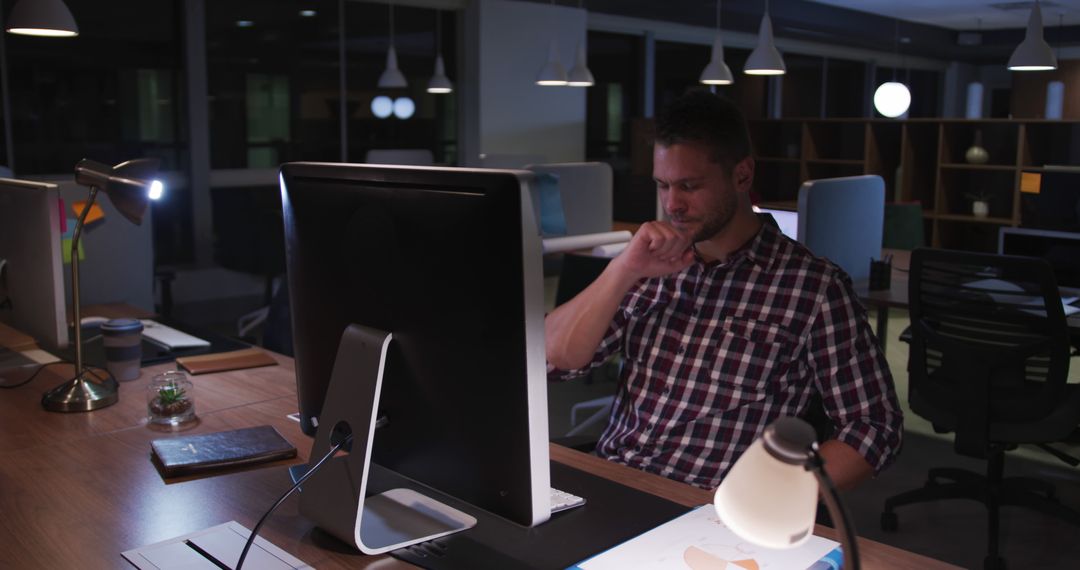 Dedicated Businessman Working Late at Night in Modern Office