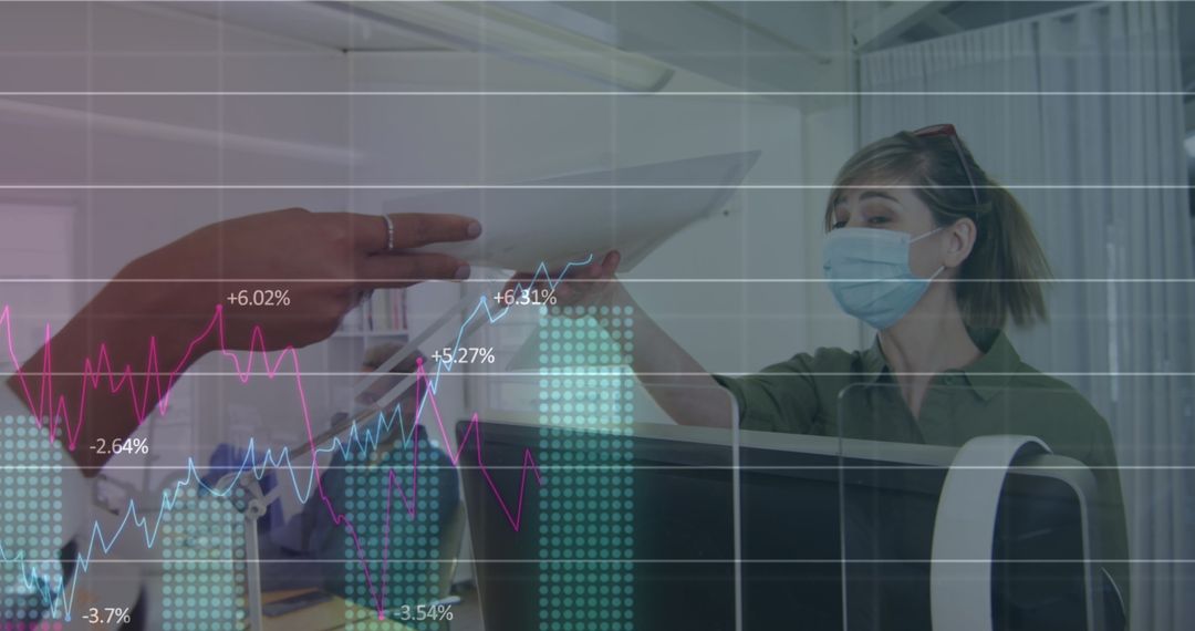 Colleagues Analyzing Data with COVID-19 Safety Measures in Modern Office