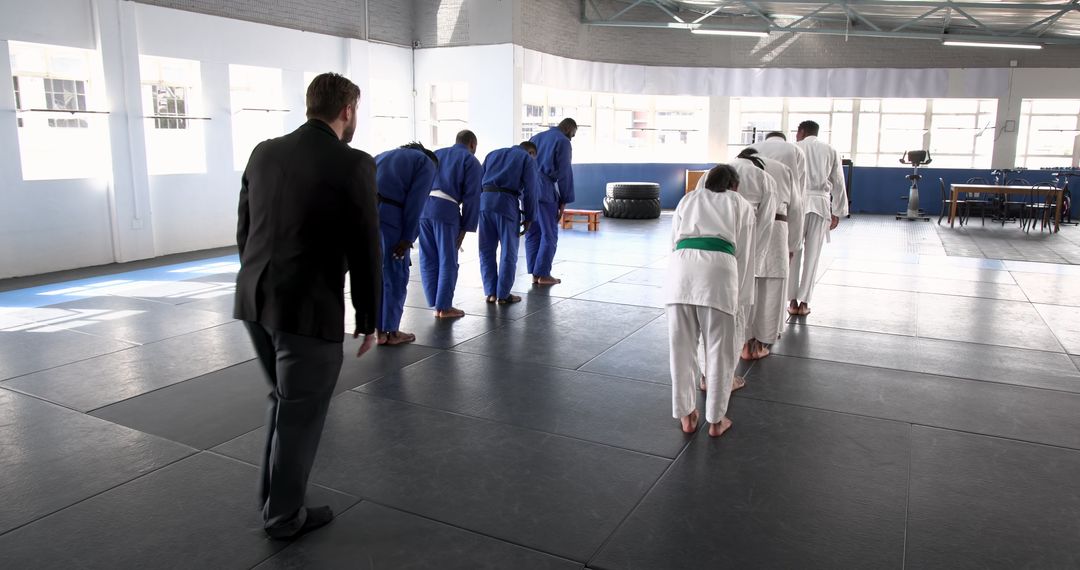 Martial Arts Class Bowing on Mats in Dojo