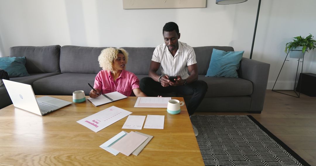 Friends Collaborating on Project with Laptop and Smartphone